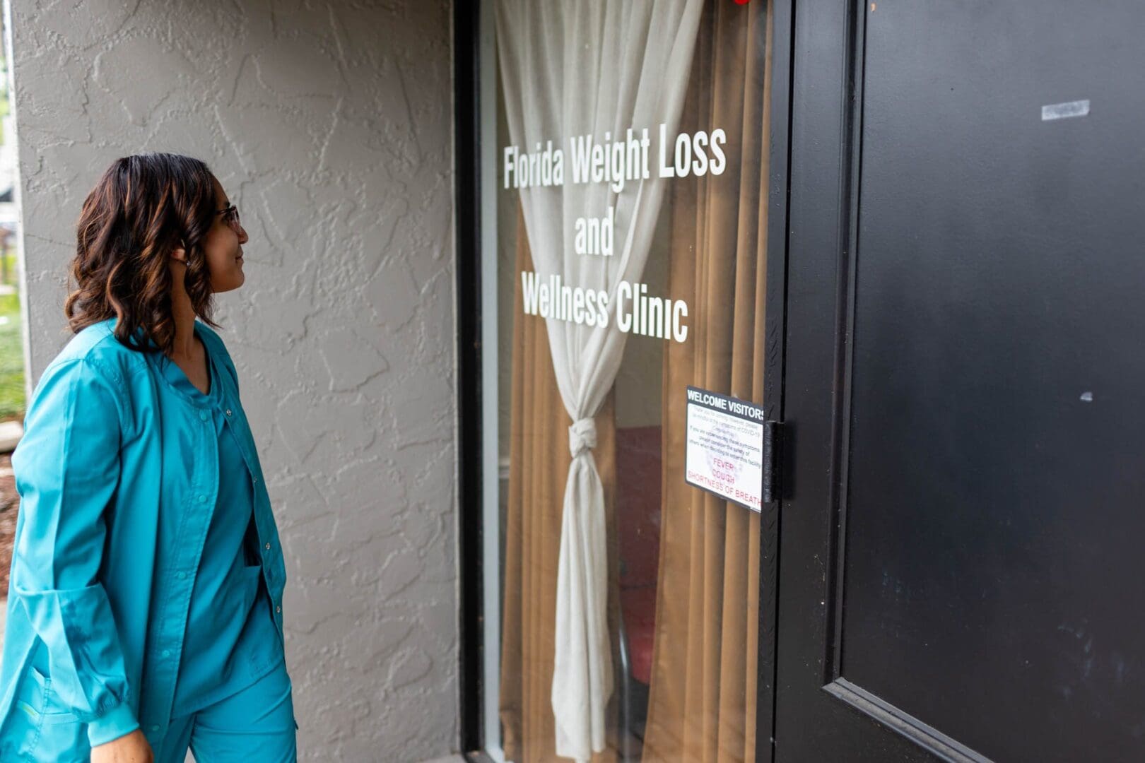 Person entering weight loss and wellness clinic.