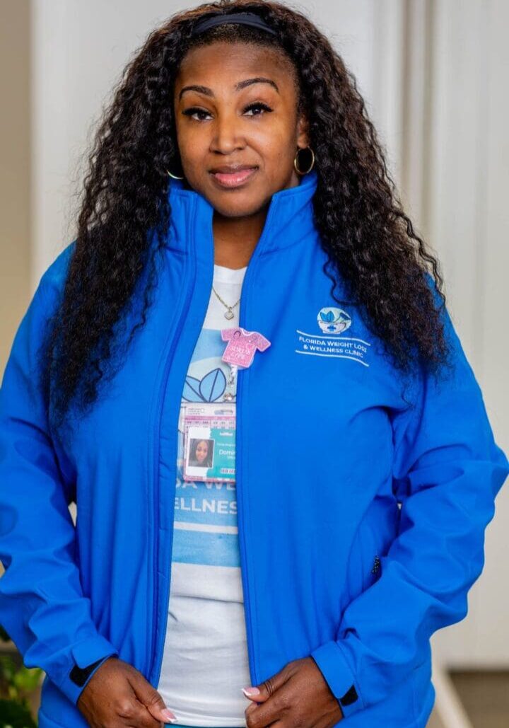 Woman in blue jacket with long hair.