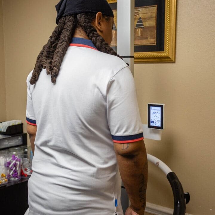 Person using medical equipment in a room.